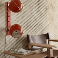 Red Wall Lamp With Metal Bracket On Striped Textured Wall And Wooden Chair