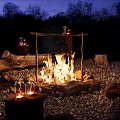 Outdoor Nighttime Campfire Scene With Stone Circle Wooden Stumps And Lit Lanterns