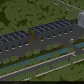 Modern Industrial Factory With Solar Panels On Roof Surrounded By Green Trees And Vegetation