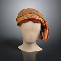 Orange Textured Headscarf With Green Leaf Pattern Red Trim Tied On Mannequin Head