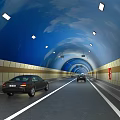 Well Lit Road Facilities in Tunnel with Traffic Lanes and Moving Vehicles