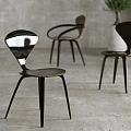Modern Leisure Chairs With Unique Curved Back And Metal Legs In Concrete Interior
