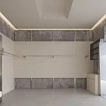 Modern Minimalist Clothing Store Entrance Featuring Clothing Racks Mirror And Shutter