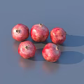 Five Fresh Red Pomegranates on Gray Surface with Natural Shine