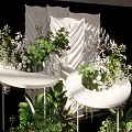 Elegant White Decorative Structure With Green Plants On Black Display Stand 3d model