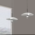 Two Modern White Pendant Lights With Round Shades Near Window Blinds And Bright Bulbs