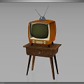 Vintage Orange Television With Antenna And Green Screen On Wooden Table