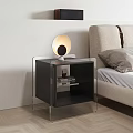 Modern Glass Top Nightstand With Metal Frame And Round Table Lamp Next To Upholstered Bed