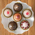 Dining Table Setup With White Cake Stand And Colorful Pastries Topped With Chocolate Strawberries Cherries