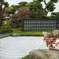 Traditional Karesansui Japanese Rock Garden with Raked Sand Stones Pine Trees and Green Foliage