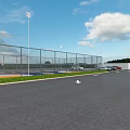 Fenced Outdoor Basketball Court With Blue And Yellow Surface Two Hoops Benches And Lighting Poles
