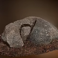 Natural Stone And Wood Pieces Piled Together With Earthy Soil In Natural Setting
