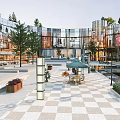 Modern Commercial Street With Glass Facade Buildings Open Plaza Green Trees And Outdoor Seating