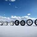 Car Tires With Various Stylish Designs Arranged On White Ground Under Cloudy Blue Sky