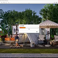 Garden Landscape with Tent Campfire Parasol Chairs and Lush Green Plants