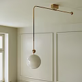Modern Brass Pendant Light With White Spherical Shade In Room With White Walls And Window