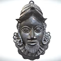 Intricate Traditional Bronze Mask With Detailed Carved Facial Features And Ornamental Headgear