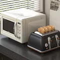 White Microwave And Black Toaster On Kitchen Countertop With Toasted Bread And Window Blinds