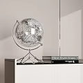 Elegant Globe Decorative Ornament Set With Silver Stand On White Cabinet And Books