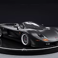 Black Convertible Sports Car With Shiny Exterior On Circular Display Platform
