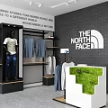 The North Face Clothing Store with Hanging Apparel Poster Display and Green Plants