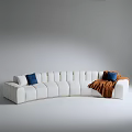 Modern White Irregular Sofa With Curved Design Blue Cushions And Brown Blanket