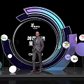 Speaker On Modern Event Stage With Round Decorations And Brand Logos