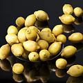Fresh Ripe Lemons on Plate and Scattered on Black Surface with Reflections