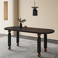Stylish Black Oval Dining Table With Wooden Legs And Decorative Vase