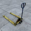 Yellow Forklift Pallet With Metal Handle On Gray Concrete Floor Surface