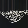White Floral Cluster Chandelier Hanging With Gold Strings On Black Backdrop