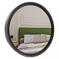 Round Black Frame Mirror Reflecting Green Headboard Bed With Pillows And Light Paneled Wall