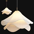 Two Illuminated White Pendant Lights With Pleated Wavy Lampshades And Golden Rods On Black Background