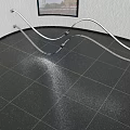 Indoor Area With Textured Wall Square Window And Curved Silver Metal Sculpture On Dark Tile Floor