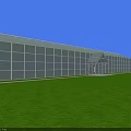 Industrial Factory Building With Large Glass Walls Front Entrance Green Lawn And Blue Sky Background