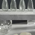 Contemporary White Ceramic Vessel Sink with Chrome Faucet Glass Vases and Soap on Gray Countertop