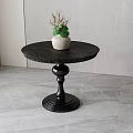 Modern Round Coffee Table With Dark Stone Tabletop Black Base White Pot And Green Plant