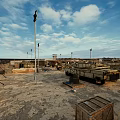 Open Industrial Area With Light Poles Wooden Crates Metal Structures And Cloudy Sky