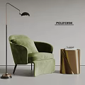 Green Velvet Accent Chair With Gold Side Table And Books Near Floor Lamp