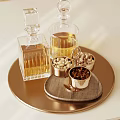 Elegant Gold Tray With Transparent Glass Bottles And Metal Bowls Of Nuts