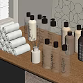 Stylish Display of Rolled Towels and Fragrance Bottles on Wooden Shelf