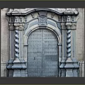 Historic Architectural Scenery Featuring Arched Deep Green Metal Door Twisted Columns And Carved Top Decoration