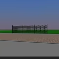 Black Wrought Iron Fence with Intricate Patterns and Spiked Tops Green Grass and Brick Ground