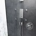 Modern Chrome Rainfall Shower System With Multiple Spray Jets And Handheld Wand On Gray Wall 3d model