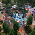 Outdoor Children's Play Area With Colorful Circular Design And Lush Green Trees