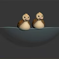 Two Adorable Small Duck Toys Sitting In Blue Decorative Bowl