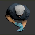 Woman in blue scrubs white cap and blue gloves with hands crossed against gray background