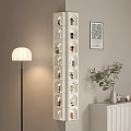 Elegant White Decorative Cabinet With Multi Tiered Shelves Figurines Floor Lamp And Potted Plant