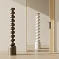 Brown and White Stacked Sphere Sculptures with Cylindrical Bases in Soft Light Interior