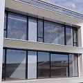 Duplex Villa Modern Exterior With Large Glass Windows Multi Floor Design Greenery And Blue Sky Surroundings